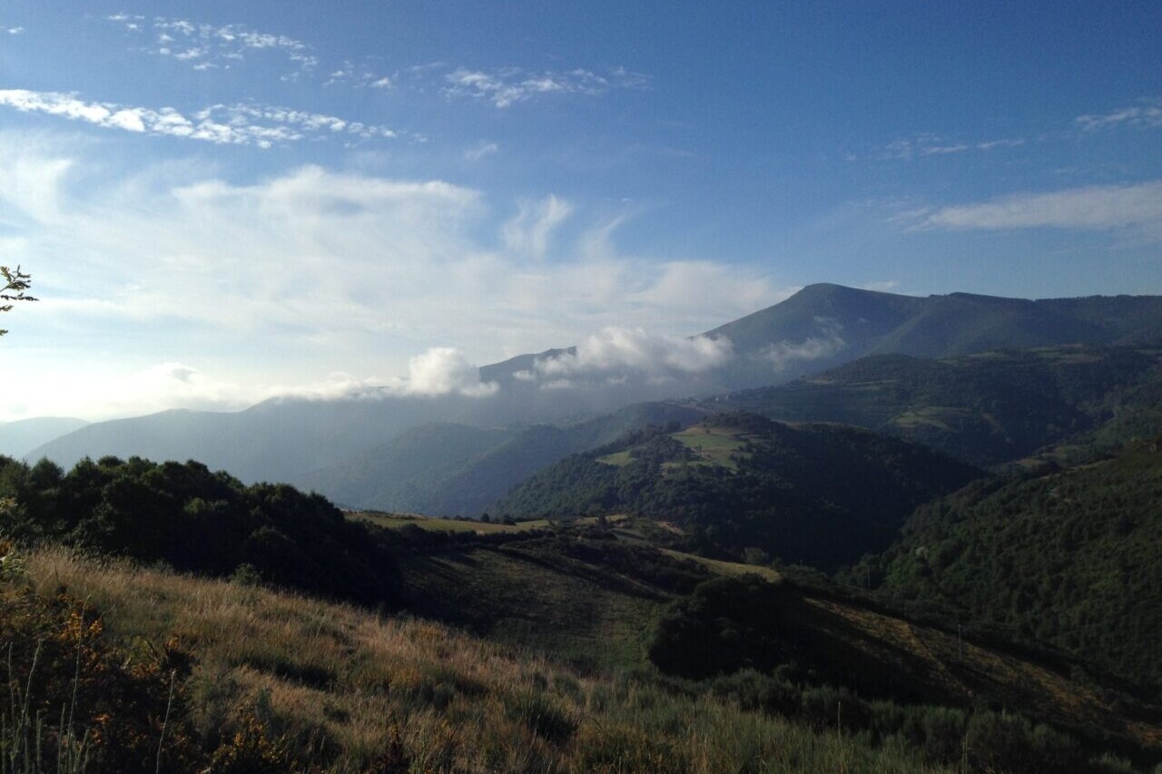 A view looks over distant mountains and blue skies.