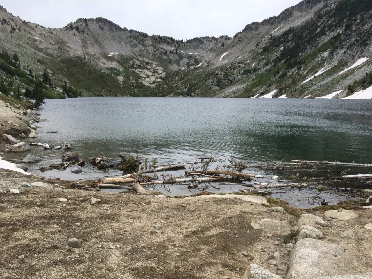 An alpine lake is surrounded by rocky mountain ridges.