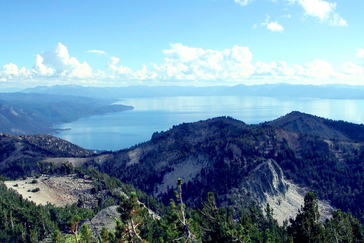 A view shows mountains and a blue lake.