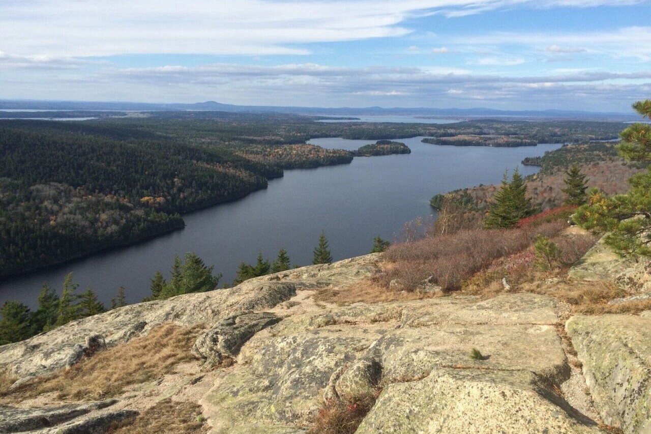 A rocky ridge overlooks a lake.