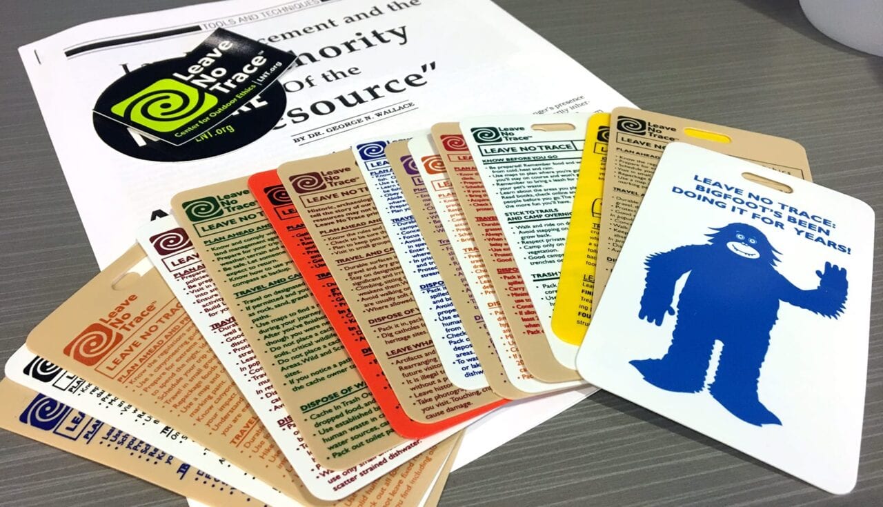 A set of cards and stickers about Leave No Trace lie on a table.