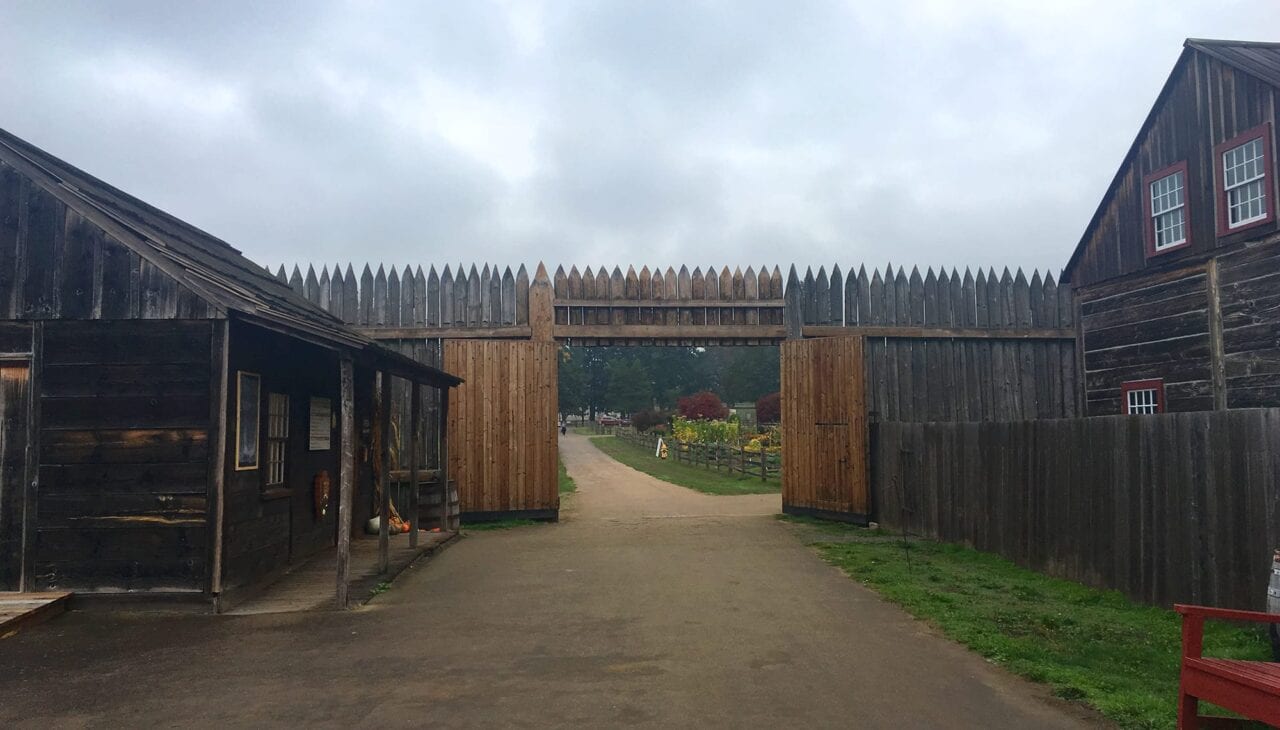 a wooden gate at Fort Vancouver is open to a garden beyond.