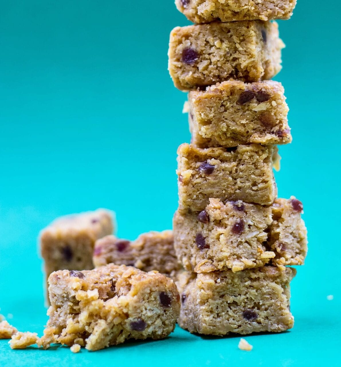 Granola bars are stacked up against a blue background.