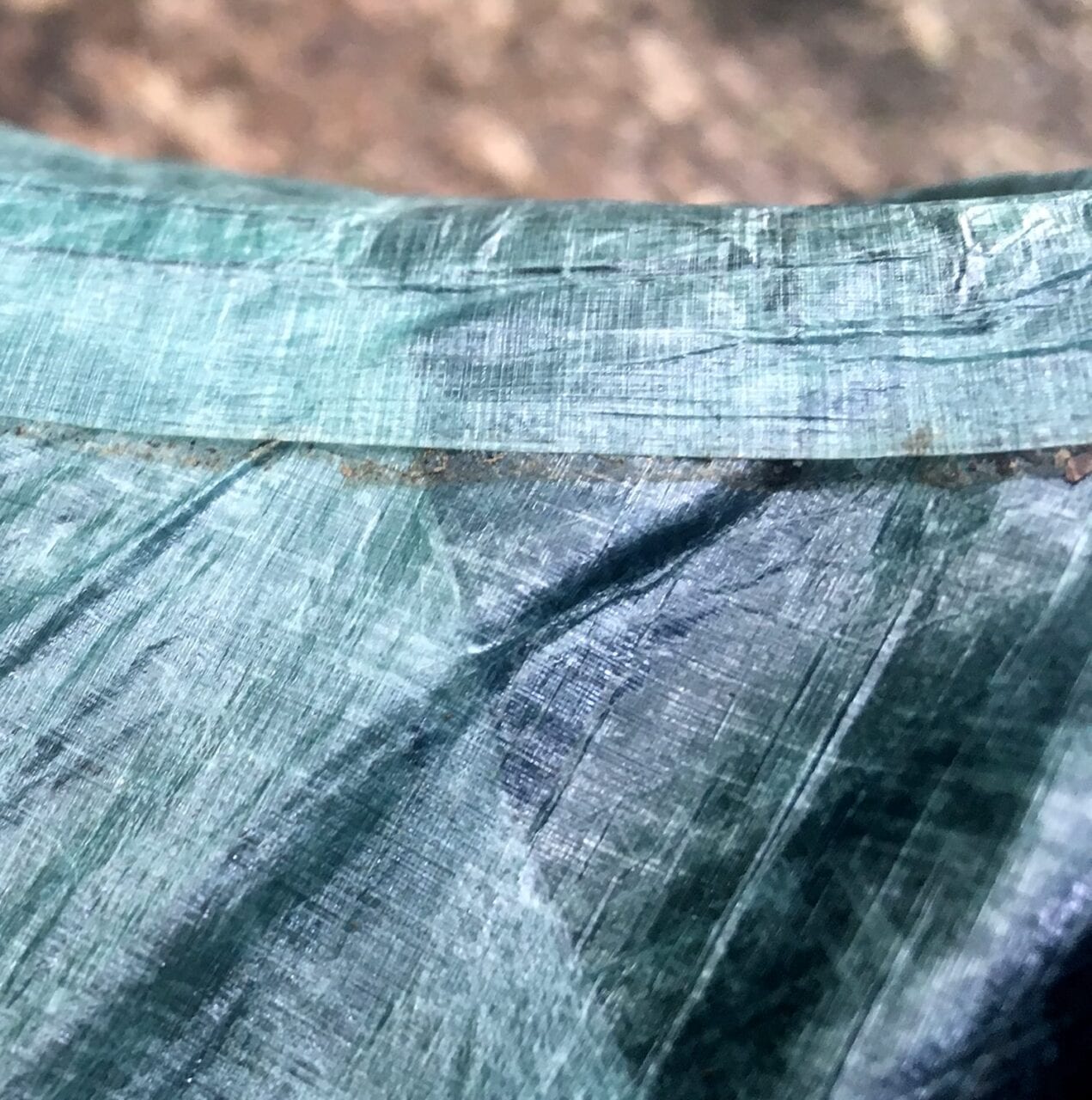 A worn out tent seam in need of some minor repair.