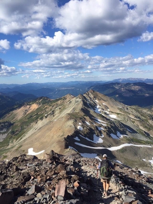 A thru hiker hiking on top of mountains.