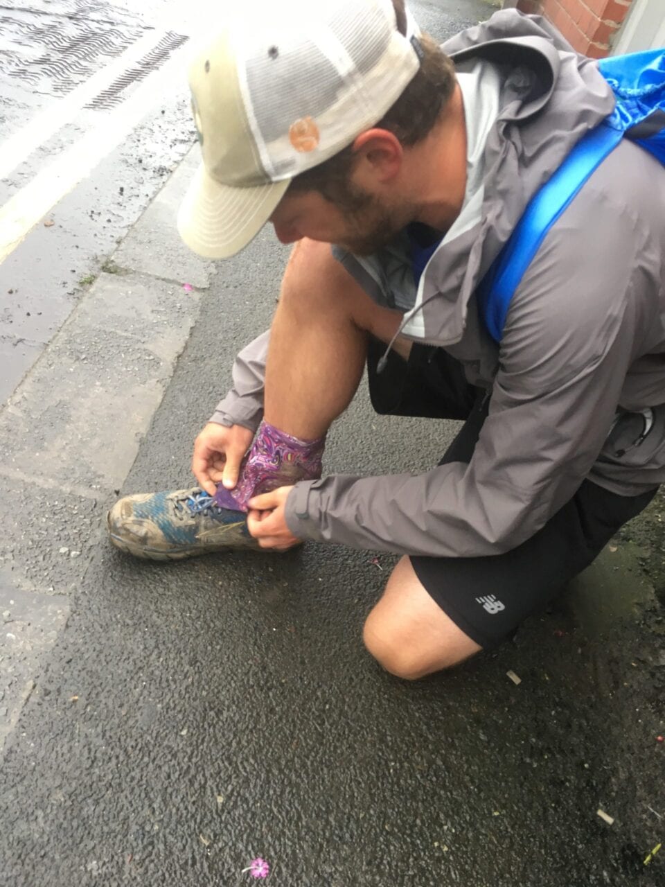 A hiker getting his shoes ready for a day on the trail