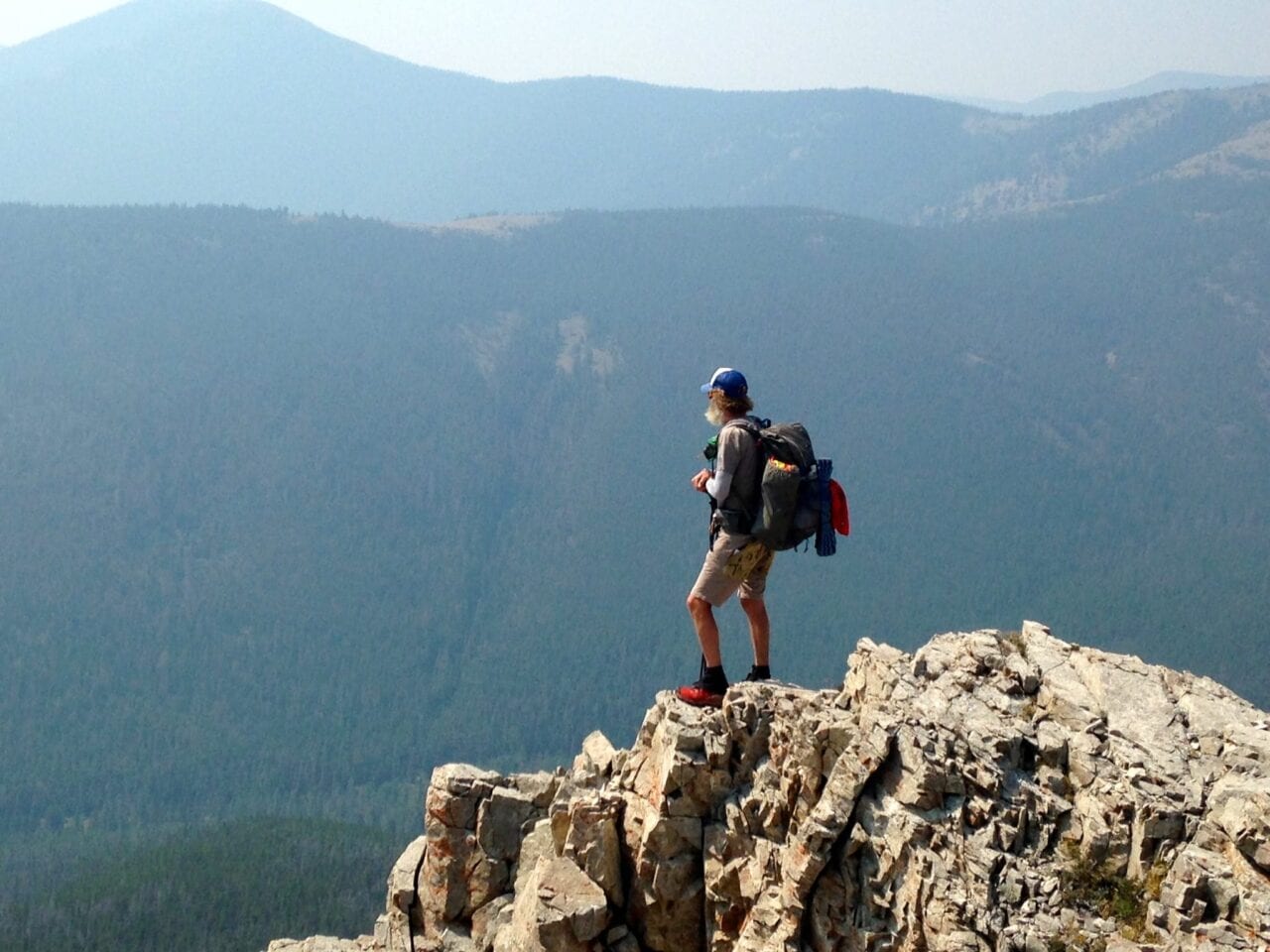 A hiker standing on a mountain.