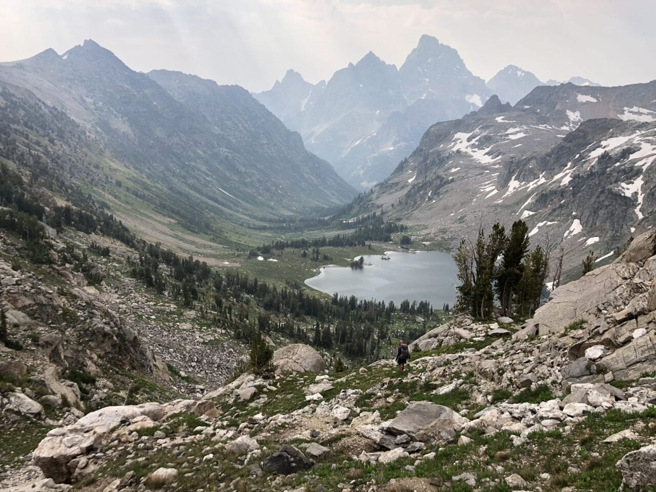 A view of mountains with a lake in the middle at the base.