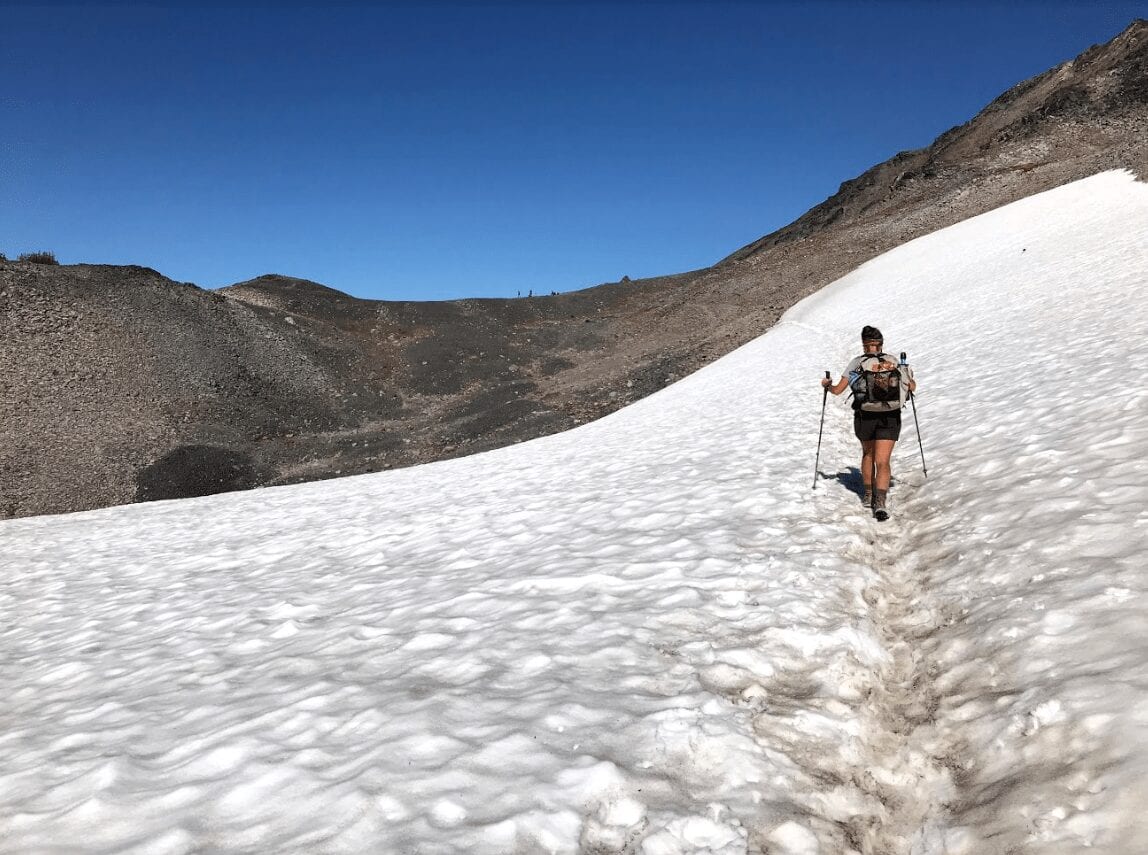 A hiker hiking in the snow.