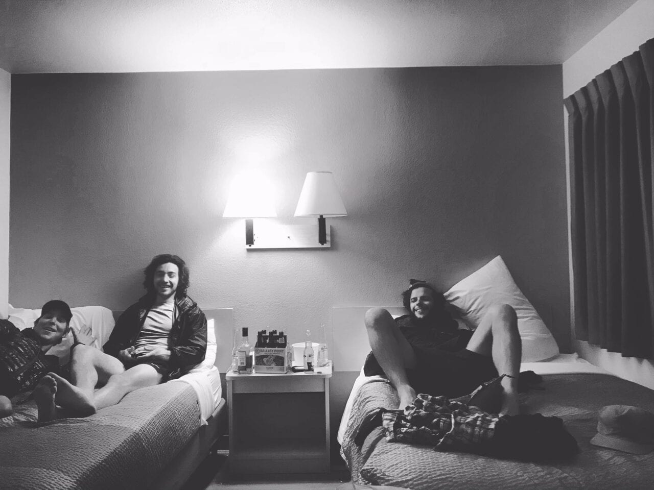 Hikers relaxing on beds in a cabin room.