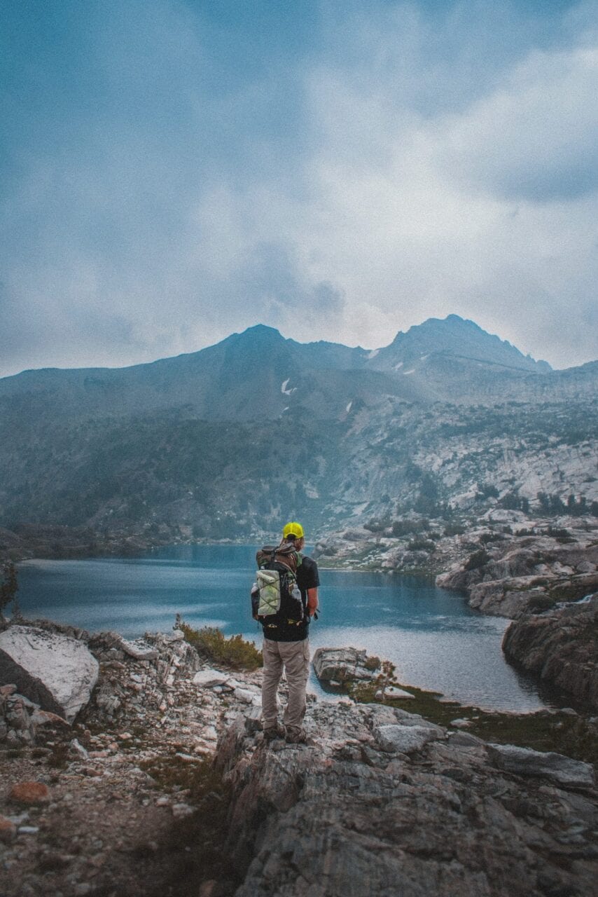 A hiker looking out at a lake.