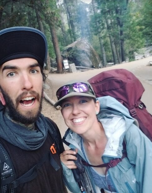 Two hikers smiling on the Appalachian Trail.