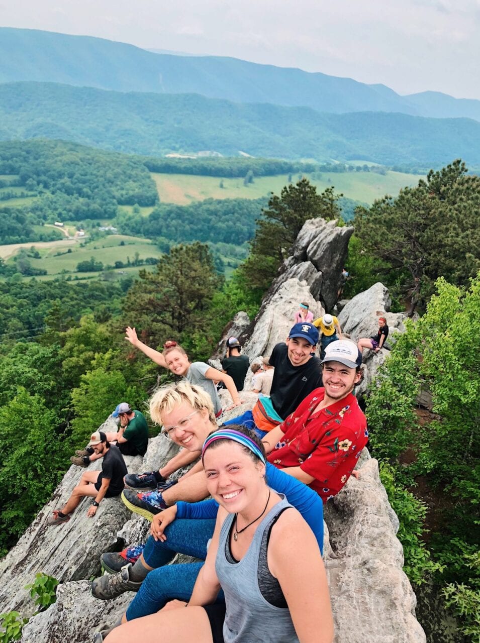 A group of hikers sitting on a hill on the Appalachian Trail.
