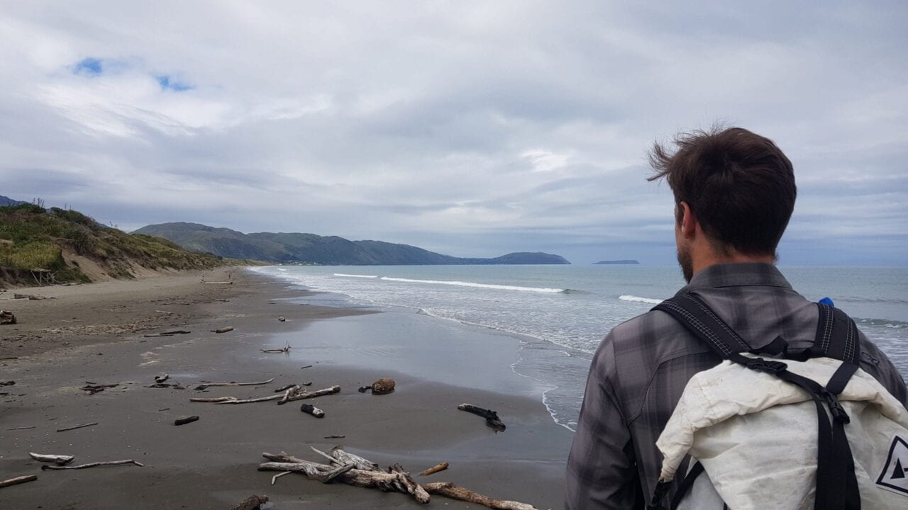 A man on a beach in New Zealand.