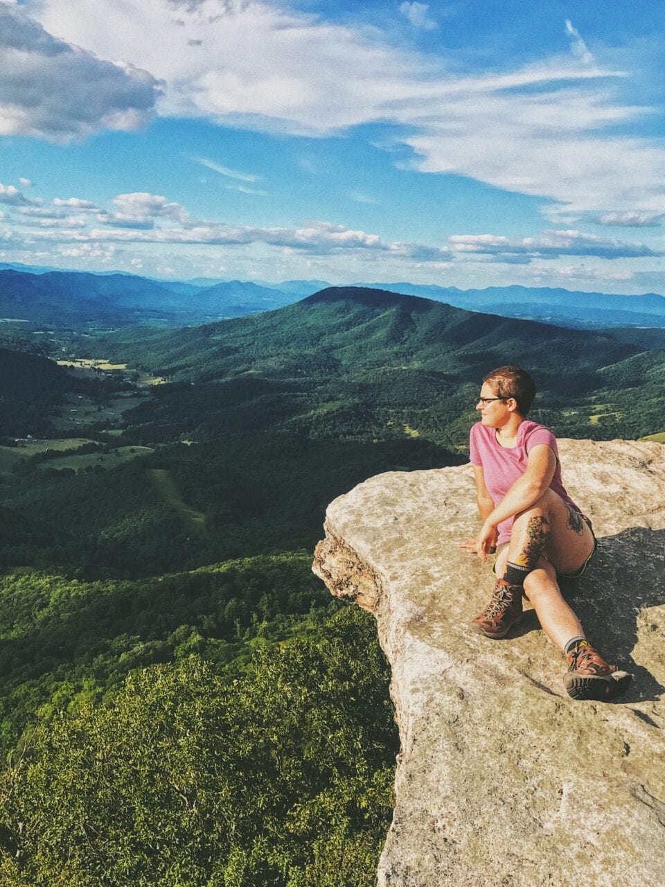 A hiker sits on a cliff on the Appalachian Trail.