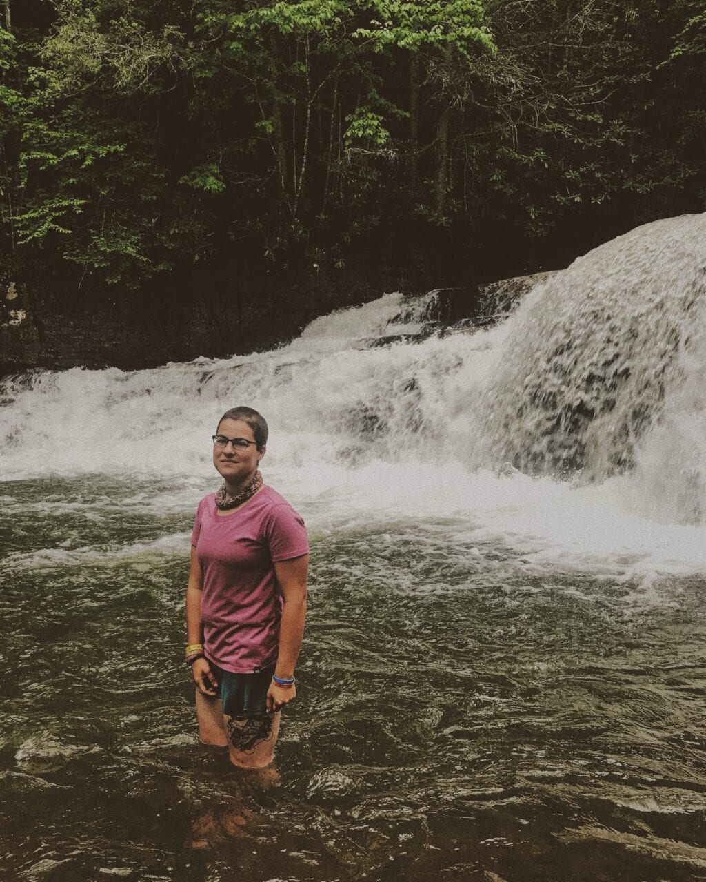 A woman standing in a river.
