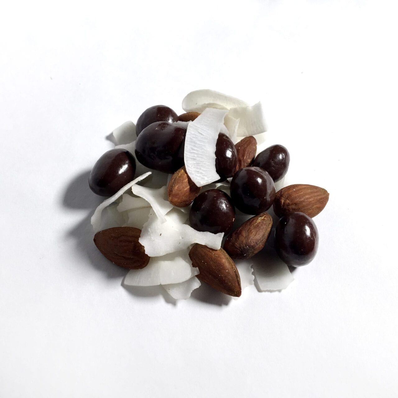 A pile of GORP trail mix including chocolate coffee beans and coconut.