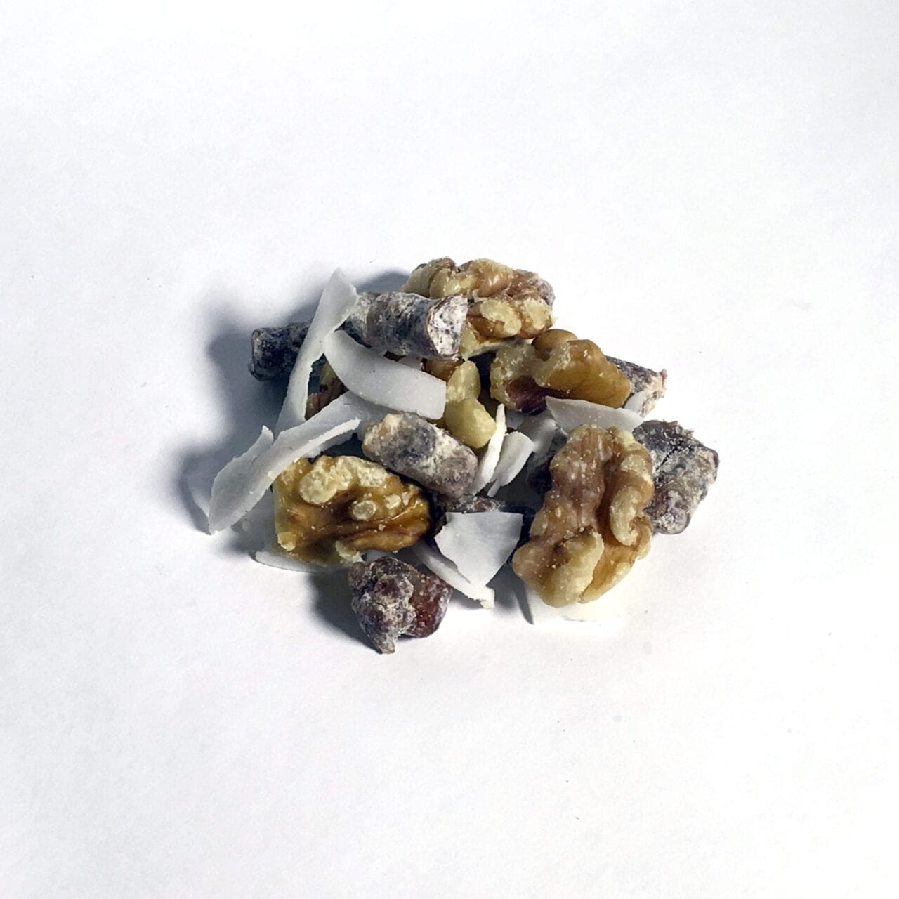 A pile of GORP trail mix including nuts and coconut.