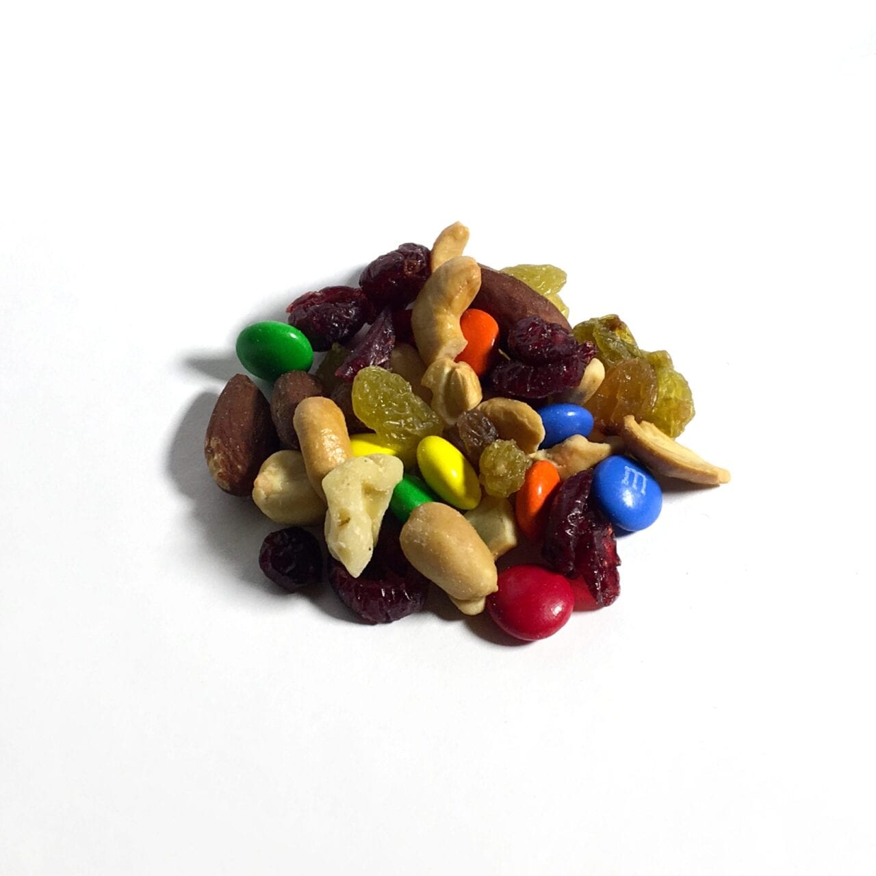 A pile of GORP trail mix including nuts and m&ms.