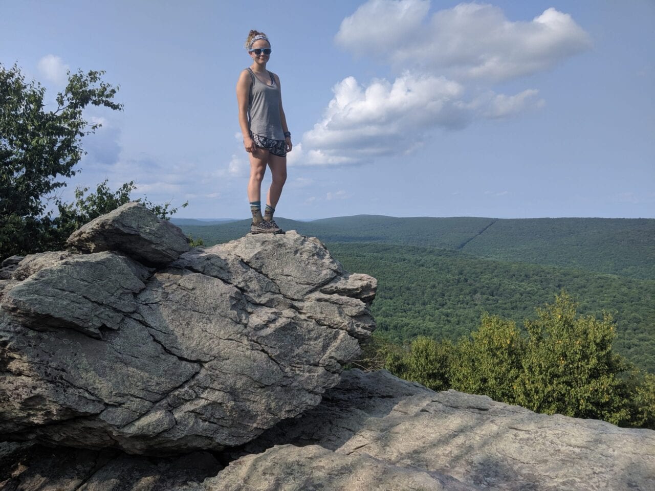 Thru-hiker on a rock ledge at the Appalachian Trail