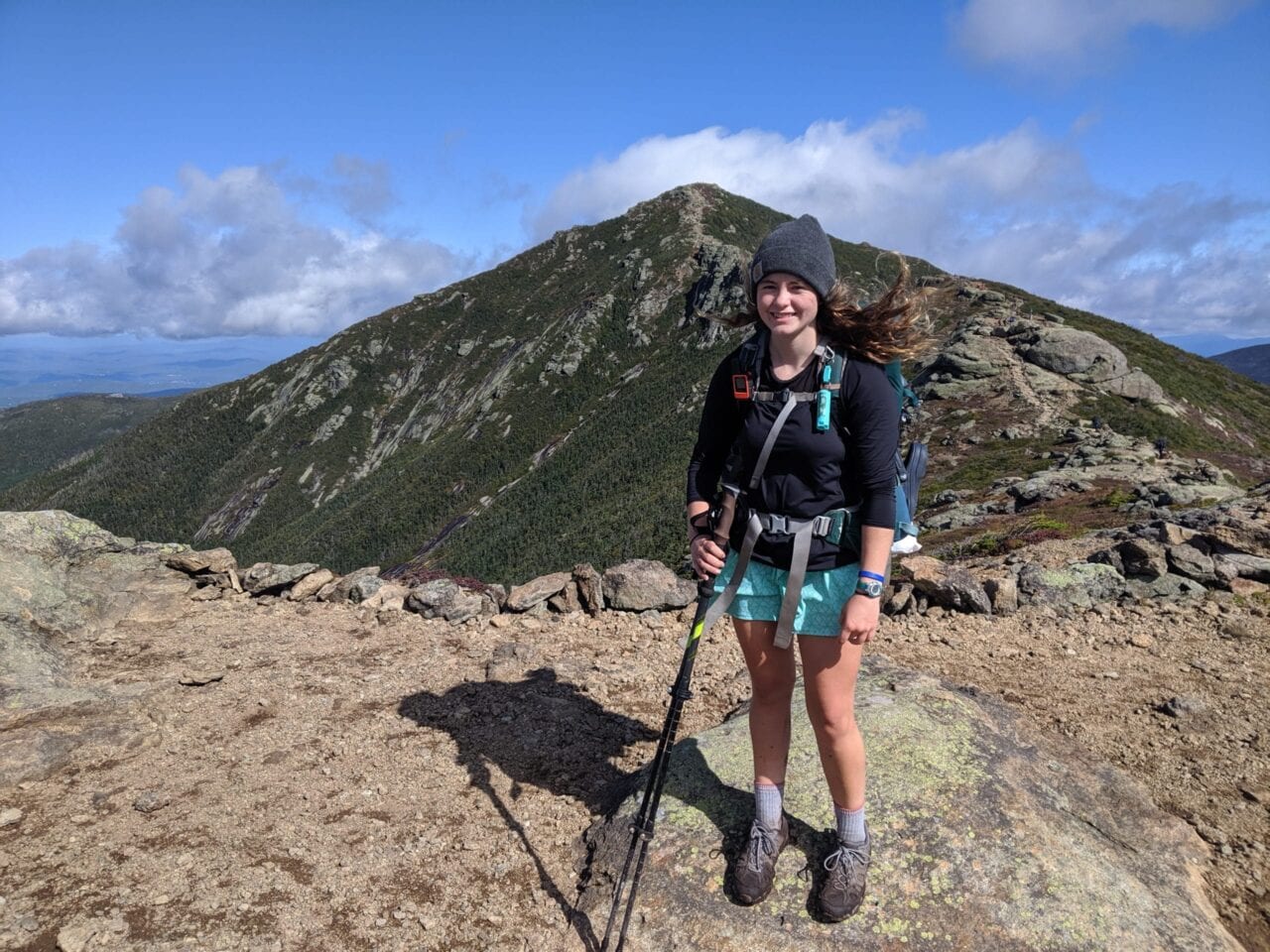 Thru-hiker on the Appalachian Trail with its mountains in the background