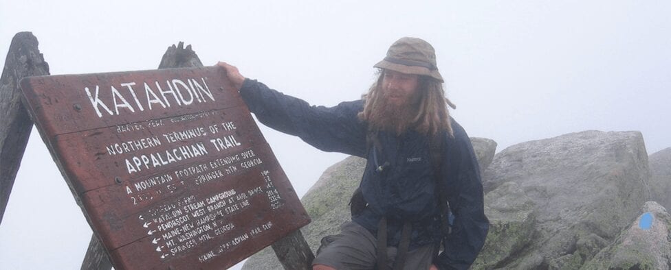 Guthook standing next to the Mount Katahdin sign.