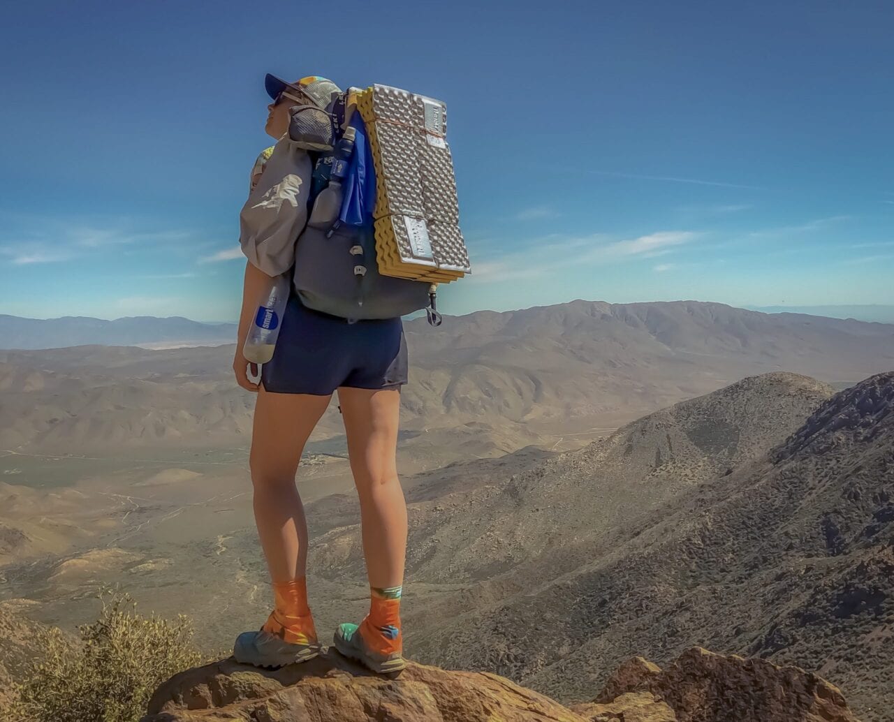 A hiker standing on a mountain.