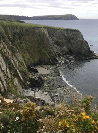 A cliff next to the ocean in the UK.