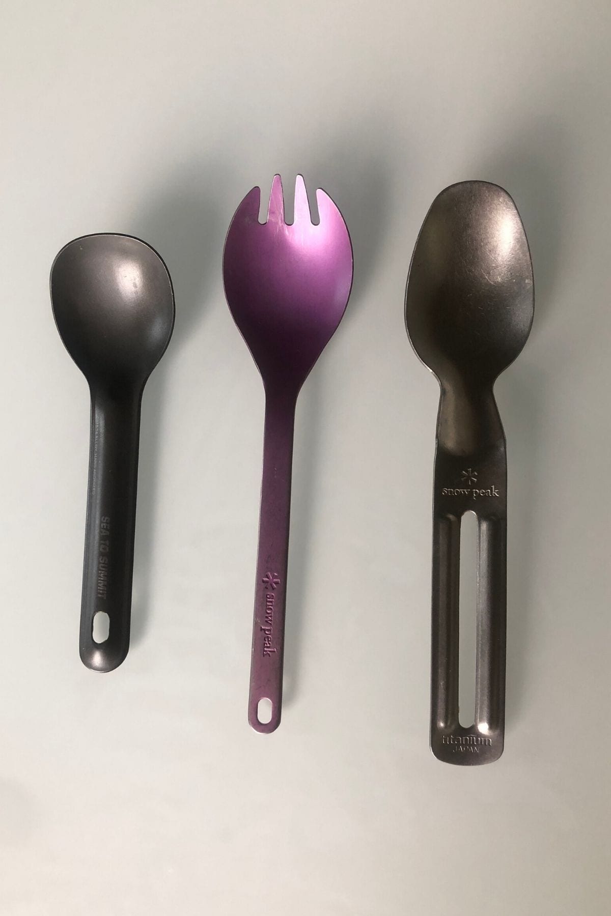 Three stainless steel spoons.