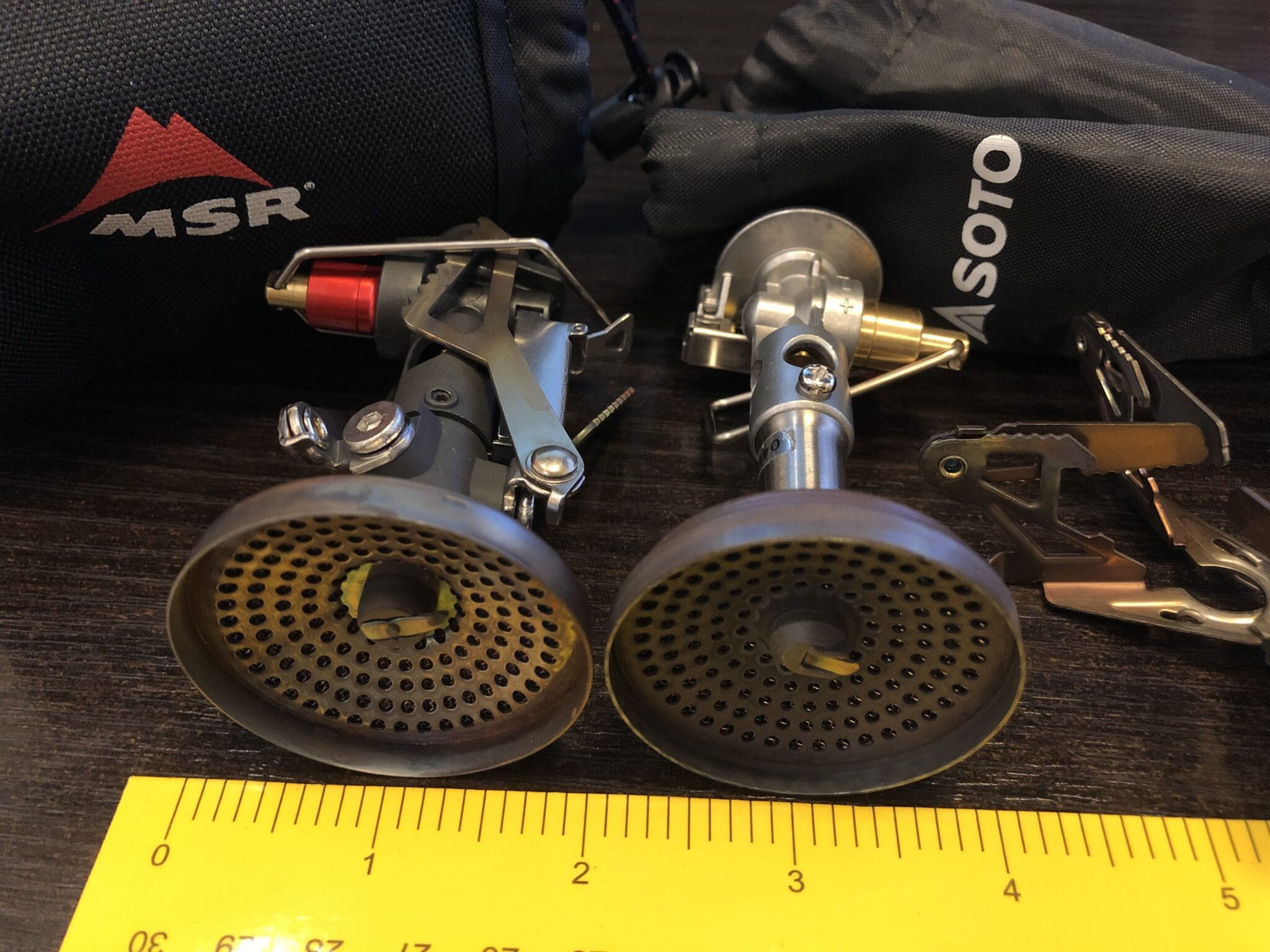 The MSR PocketRocket Deluxe stove vs the Soto WindMaster stove next to a ruler.