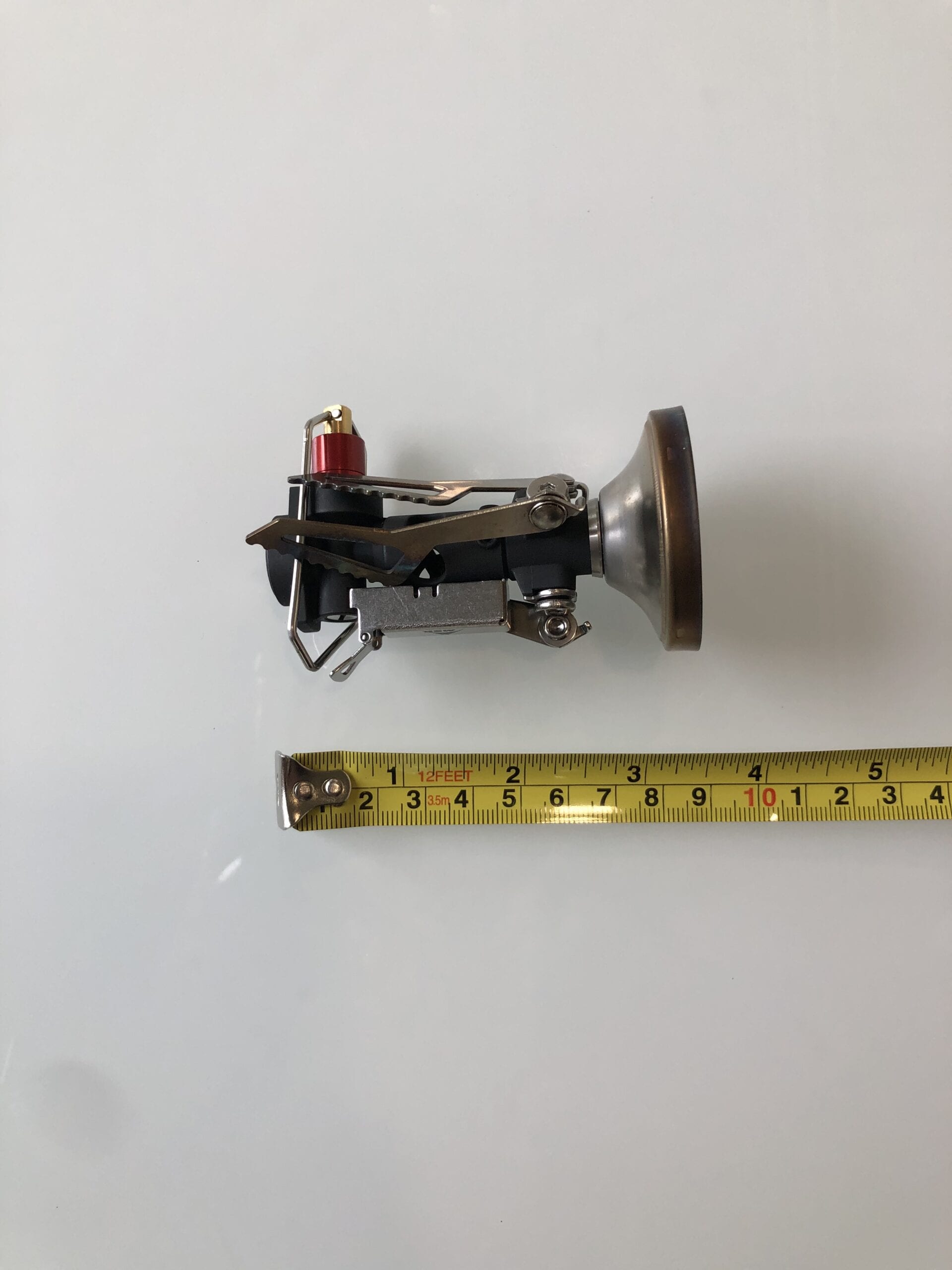 MSR PocketRocket Deluxe being measured next to a ruler.