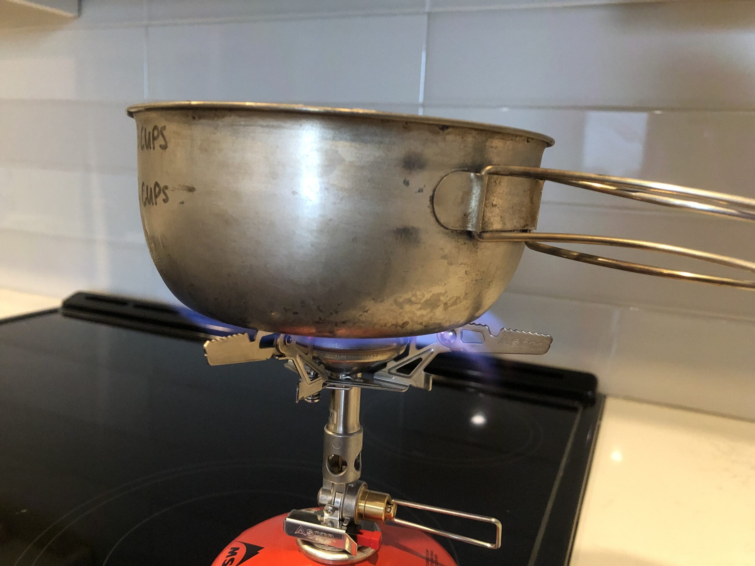 Soto WindMaster Stove attached to a fuel canister boiling a pot of water