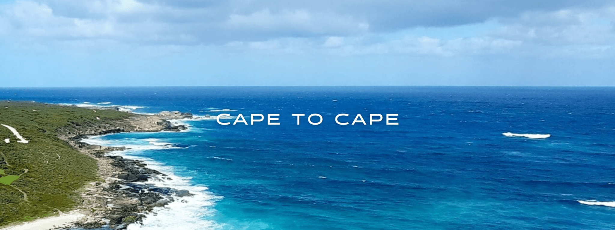 A green coast meets a blue ocean on Australia's coast.