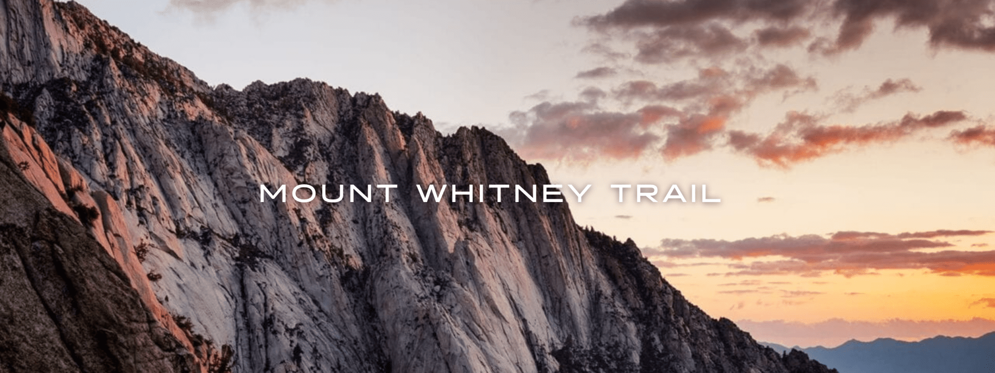 A sunrise glows behind a pale rocky ridge on the Mount Whitney Trail.