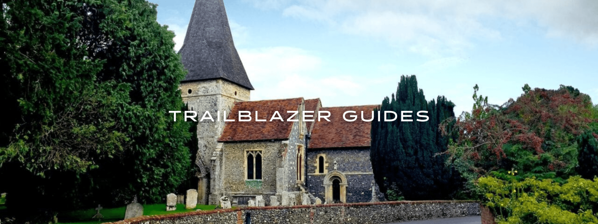A paved road leads to an old stone church on England's South Downs Way.