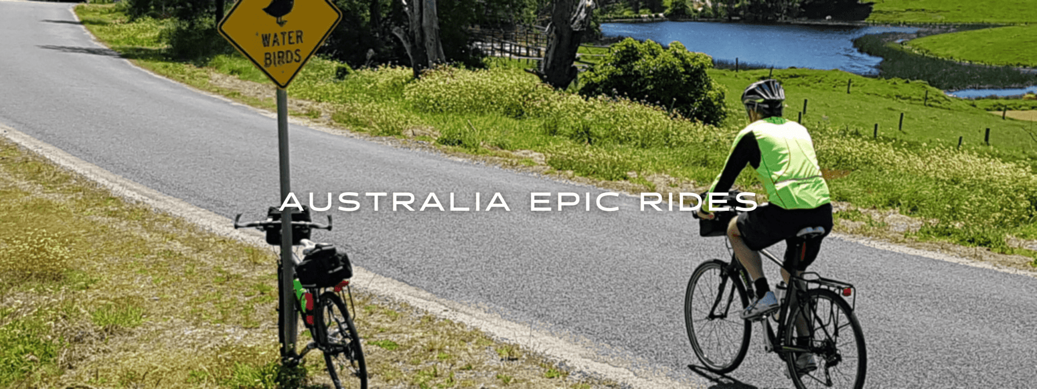 A person cycles along a paved path in Australia.