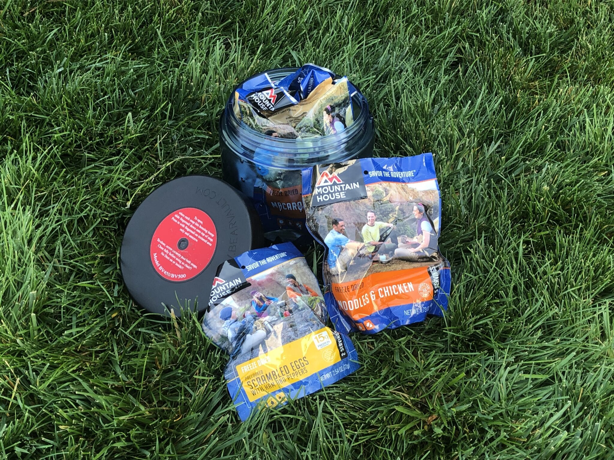 A bear canister full of Mountain House meals.