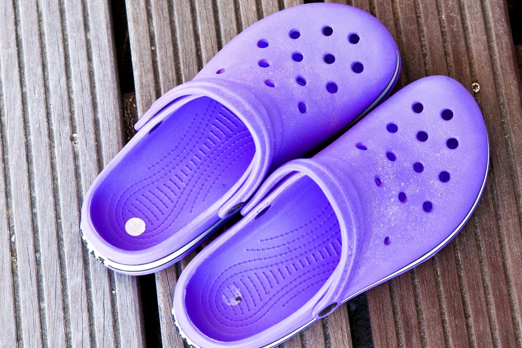 A pair of purple crocs shoes.