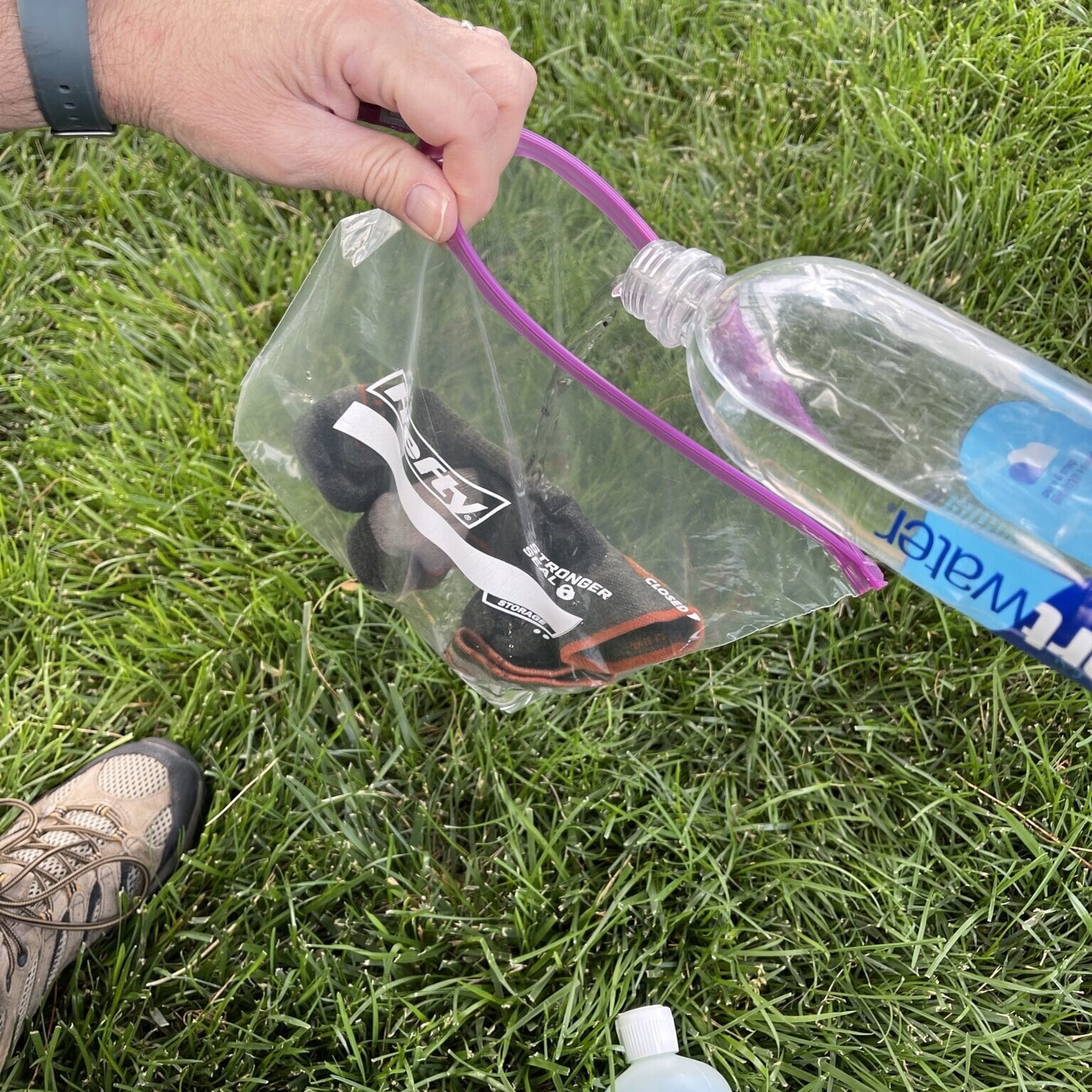 dirty socks in ziploc bag with water being poured into bag