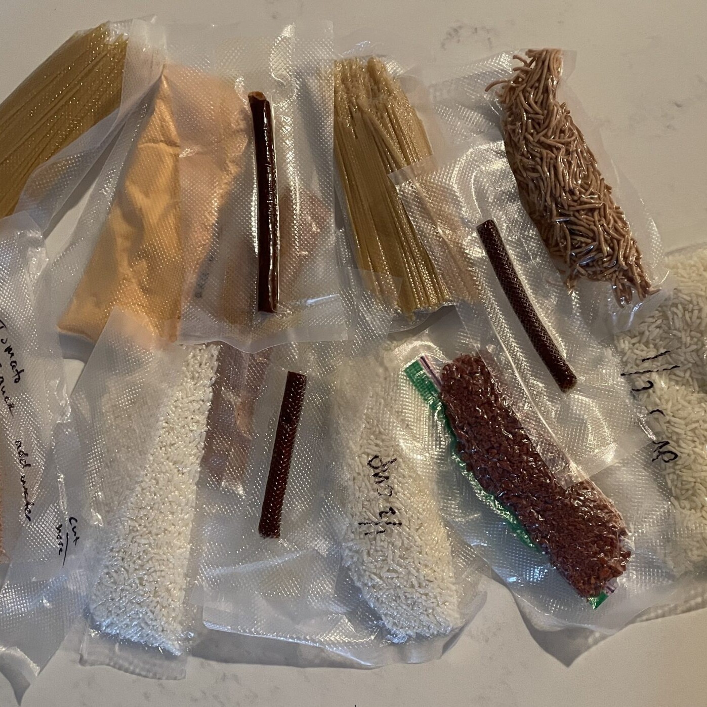 a pile of multiple different vacuum sealed foods