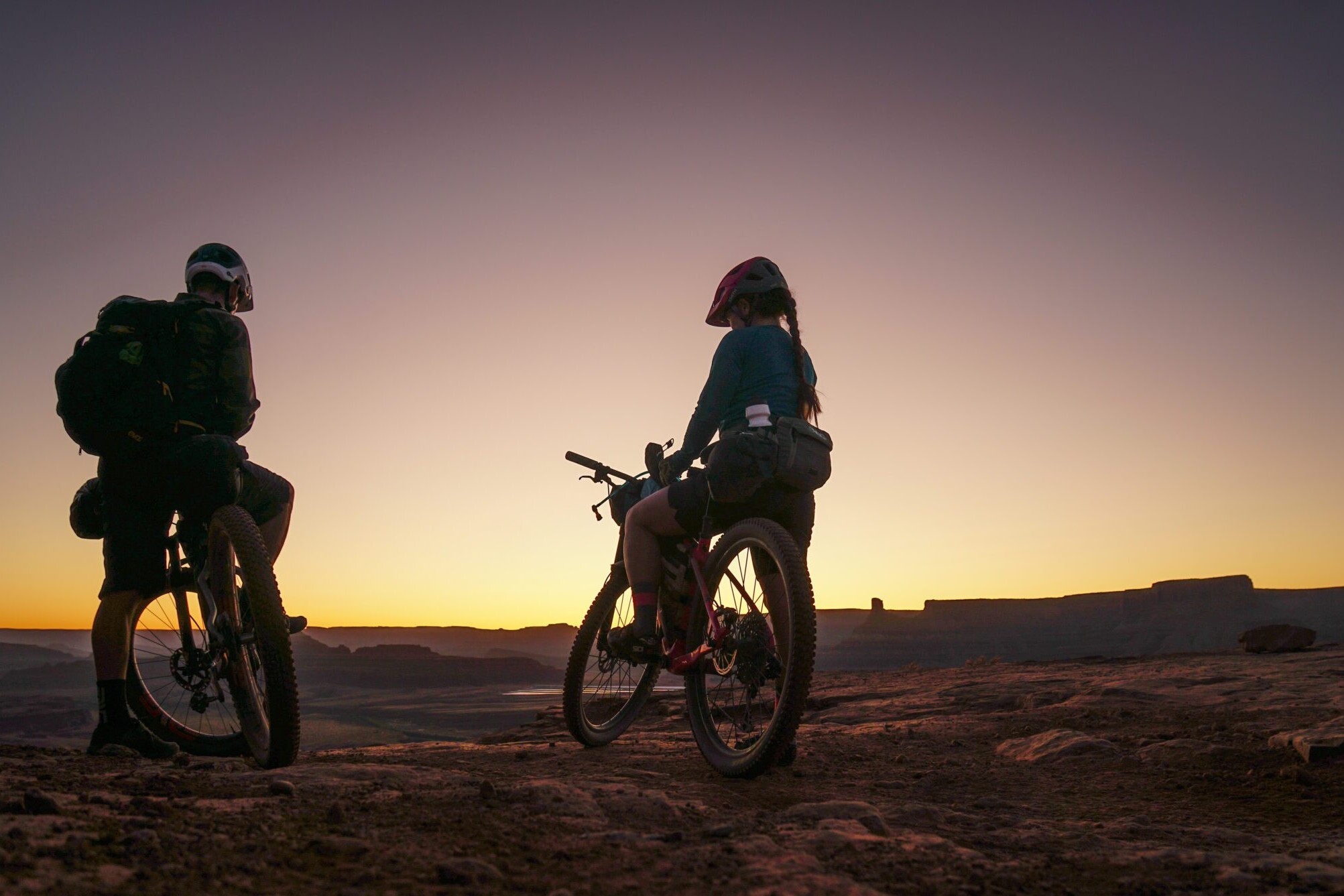 two bikepackers taking a break from biking while they sets infront of them