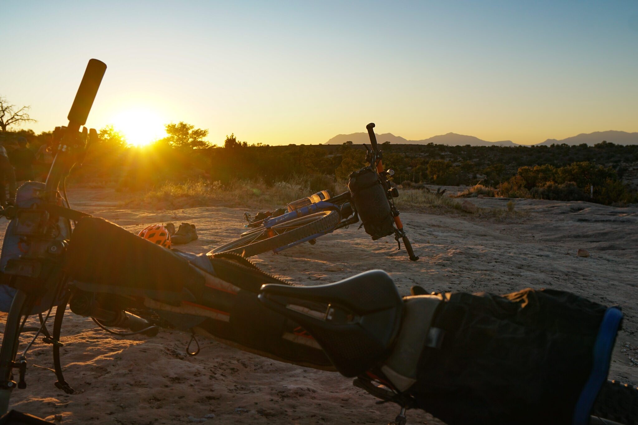 two bikepackers bikes resting during the sunset